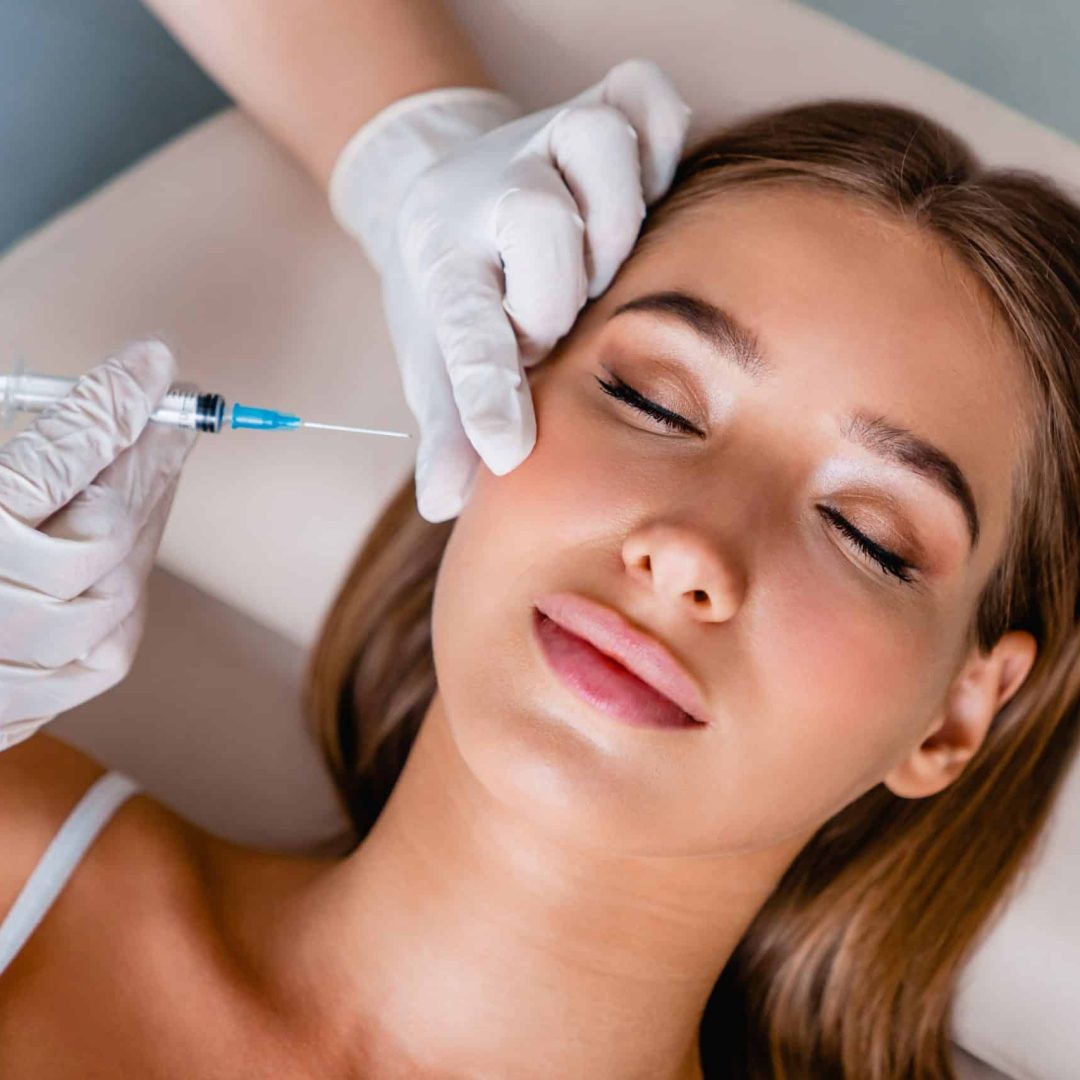 Young woman gets beauty facial injections in salon Young woman gets beauty facial injections in salon